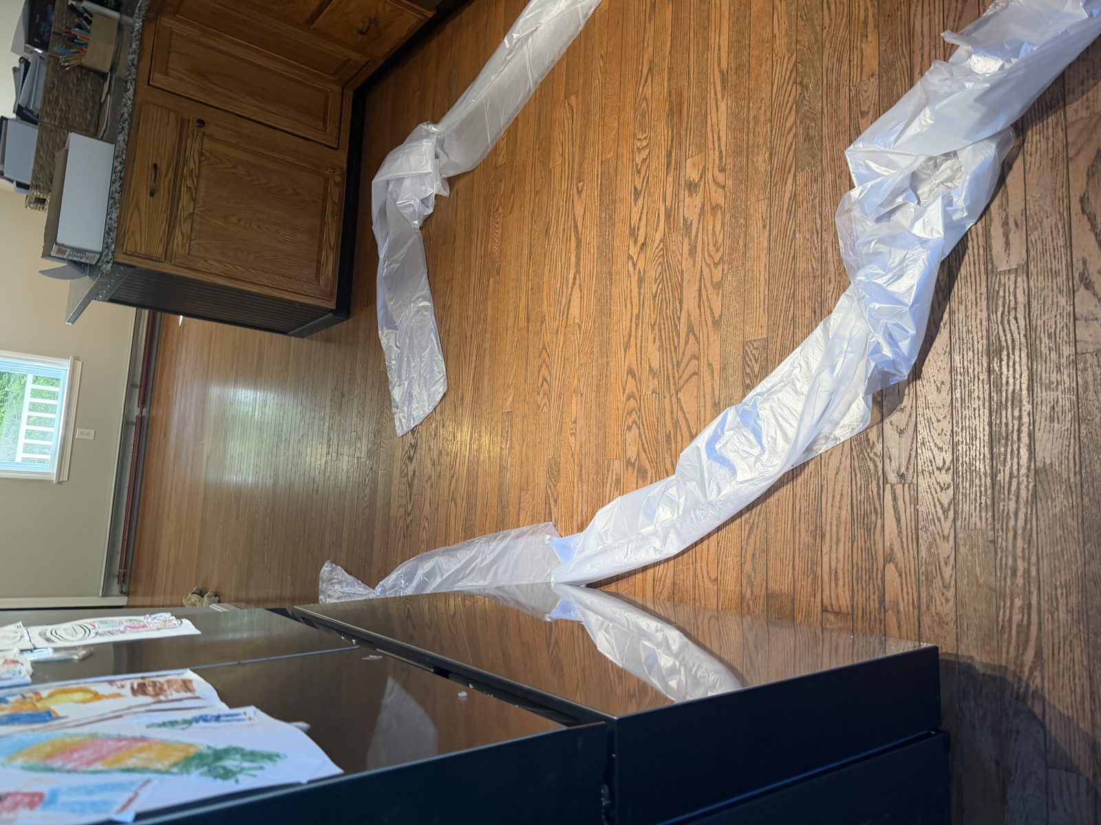 Hardwood floor sanding project in Coventry, Rhode Island — plastic sheeting and dust containment set up over the work area to protect the home